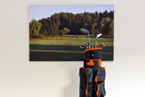 a painting hanging on a wall next to a golf course at Bett4-you Pinneberg - Prisdorf in Prisdorf