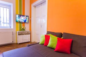a living room with a gray couch with colorful pillows at Apartment Bright & Light in Ljubljana
