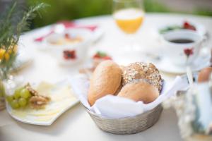 a basket of bread on a table with a cup of coffee at Hotel Heiligenstein in Baden-Baden