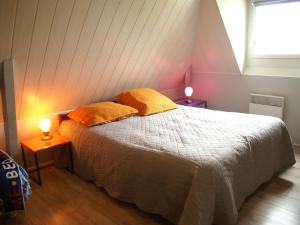 a bedroom with a bed with two pillows on it at Modern holiday home with private pool in Loubressac