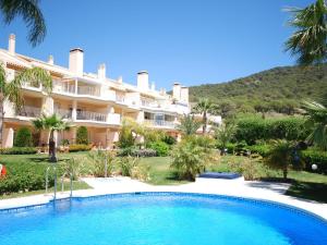 a resort with a swimming pool in front of a building at Belvilla by OYO El Mirador in Alhaurín el Grande