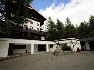 a white building with a balcony on top of it at Apartment in Aosta Valley near Ski Lift in Breuil-Cervinia