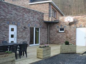 a patio with a basketball hoop on a brick building at Cozy Holiday home in Theux in Theux