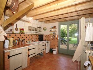 a large kitchen with wooden ceilings and a window at Romantic Loire Hideaway in Brion +32 photos