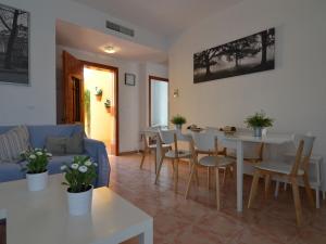 a living room with a blue couch and a table and chairs at Luxurious Holiday Home in Mazarron with Private Pool in Mazarrón