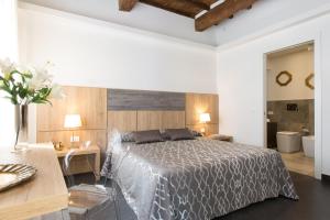 a hotel room with a bed and a desk at Sette Angeli Rooms in Florence