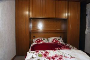 a bedroom with a bed with a wooden headboard at S.C.I. Rannerbaach in Dirbach