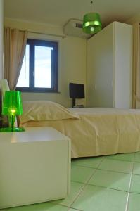 Postel nebo postele na pokoji v ubytování Residence Tre Palme