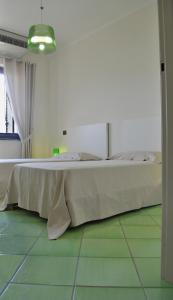 Postel nebo postele na pokoji v ubytování Residence Tre Palme