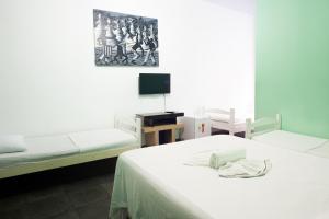 Giường trong phòng chung tại Pousada Solar dos Romanos
