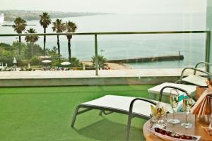 a room with a view of a beach and the ocean at Hotel Cascais Miragem Health & Spa in Cascais