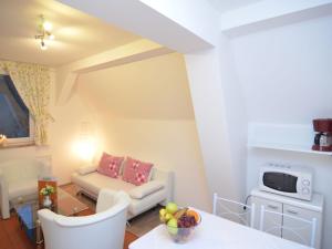 a living room with a couch and a table at Charming holiday home near the ski area in Schmallenberg