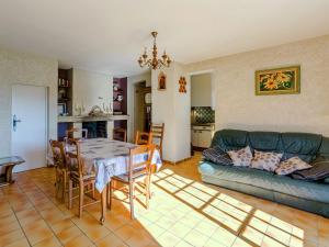 a living room with a table and a couch at Boutique Holiday Home in Bormes les Mimosas with Pool in Bormes-les-Mimosas