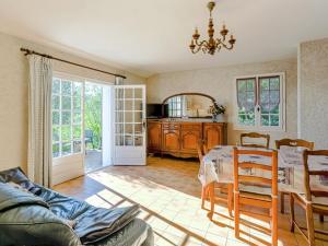 a living room with a table and a dining room at Boutique Holiday Home in Bormes les Mimosas with Pool in Bormes-les-Mimosas