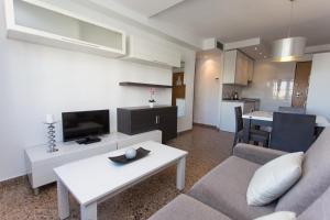 a living room filled with furniture and a tv at Pio XII Apartments Valencia in Valencia