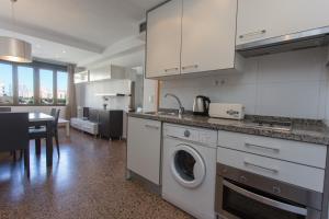 a kitchen with a stove a sink and a refrigerator at Pio XII Apartments Valencia in Valencia