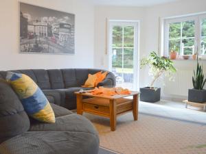 a living room with a couch and a coffee table at Apartment in Ulmen near the lake in Ulmen