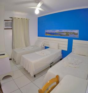 Tempat tidur dalam kamar di Pousada Águas do Forte