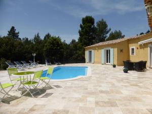 a patio with chairs and a swimming pool at Detached spacious villa with private heated pool near the Gorges du Verdon in Moissac-Bellevue