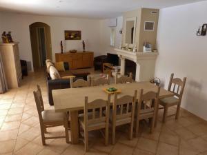 a dining room and living room with a table and chairs at Detached spacious villa with private heated pool near the Gorges du Verdon in Moissac-Bellevue