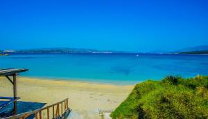 a beach with a view of the water at Aloni Studios and Apartments in Lassi
