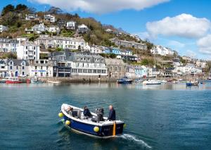 a group of people in a boat in the water at Portbyhan Hotel in Looe