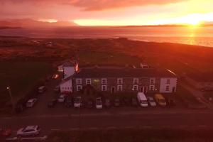 an aerial view of a house with cars parked in a parking lot at Jacks' Coastguard Cottage Vacation home in Glenbeigh