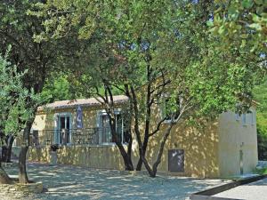 a yellow building with trees in front of it at Modern Villa with Private Swimming Pool in L denon in Lédenon