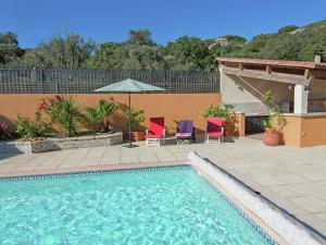 a swimming pool with two chairs and an umbrella at Modern Villa with Private Swimming Pool in L denon in Lédenon