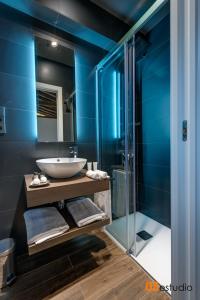 a bathroom with a sink and a glass shower at Petrus Apartment in Toledo