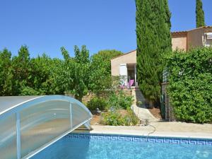 a swimming pool with a boat in a yard at Spacious holiday home with private pool in Saint-Maximin