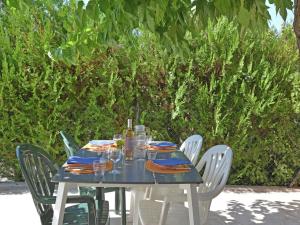 a blue table with chairs and wine glasses on it at Spacious holiday home with private pool in Saint-Maximin