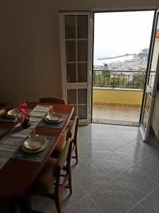 a dining room with a table and a view of the ocean at Apartment with beautiful ocean and city view in Funchal