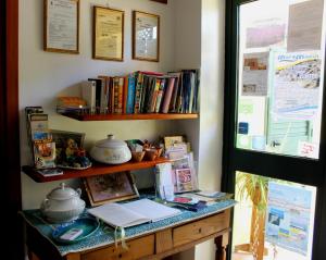 a desk with a book shelf and a laptop on it at B&B Rita E Renzo in Riola Sardo