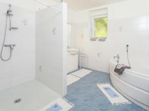 a bathroom with a shower and a tub and a sink at Amazing Holiday Home in Cazals with Terrace in Cazals