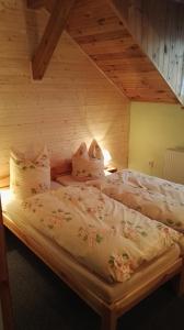A bed or beds in a room at Pension Jitka