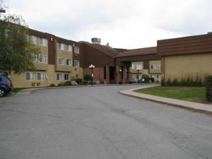 an empty parking lot in front of a building at Travelodge by Wyndham Ottawa East in Ottawa