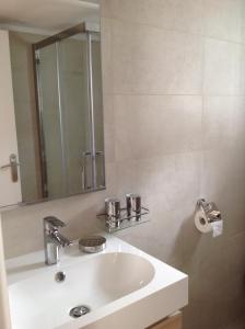 a bathroom with a white sink and a mirror at Maison d'hôtes Antoinette in Cogolin +24 photos