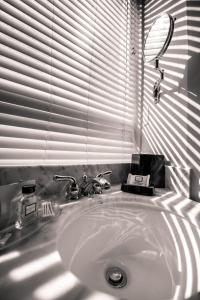 a bathroom sink with a mirror and a window at U Hotel Fifth Avenue, Empire State Building in New York