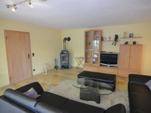 a living room with a couch and a tv at Apartment with private terrace in Prunn in Riedenburg +29 photos