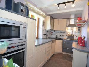 a kitchen with a microwave and a stove top oven at Apartment with private terrace in Prunn in Riedenburg