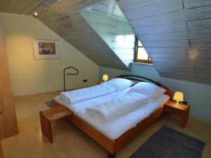 a large bed in a room with a attic at Modern Holiday Home in Prunn near Lake in Riedenburg