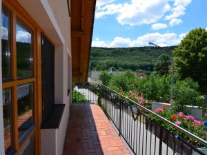 a balcony of a house with flowers on it at Modern Holiday Home in Prunn near Lake in Riedenburg