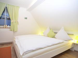 a white bed in a room with a window at Holiday home in Schmallenberg near a ski resort in Schmallenberg