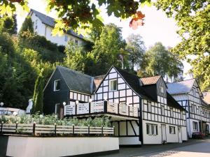 a black and white house with a garden in front of it at Pretty holiday home near the ski area in Schmallenberg