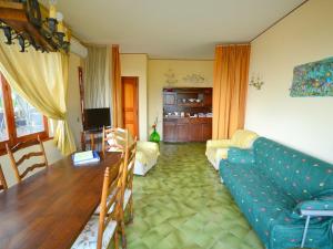 a living room with a couch and a table at Belvilla by OYO il Portico in Trecastagni