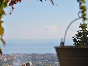 a view of a city with a wheel in the background at Belvilla by OYO il Portico in Trecastagni