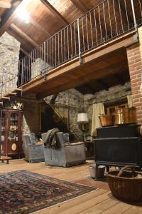 a living room with a staircase and a fireplace at Ca-Jo Bed and Breakfast in Garessio