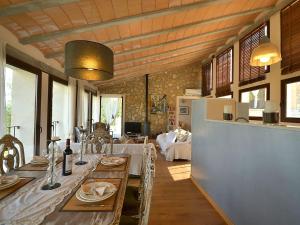 a kitchen and dining room with a long table at Belvilla by OYO Puigferrer in El Port de la Selva