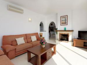 sala de estar con sofá y chimenea en Belvilla by OYO Magnolias, en Cumbre del Sol